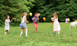 © Syda Productions - friendship, childhood, leisure and people concept - group of happy kids or friends playing tag game at birthday party in summer park