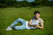 © Ben Gingell - A young adult male sitting outside on a summer's day