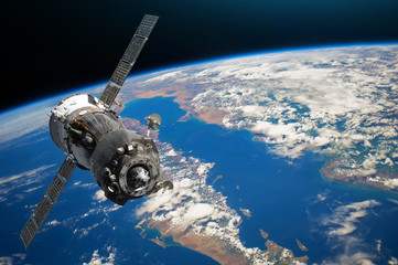 spaceship piloted by astronauts in the orbit of planet earth land and ocean, peninsula. elements of 