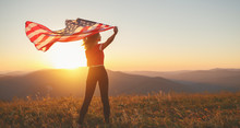 Happy Woman With Flag Of United States Enjoying The Sunset On Nature