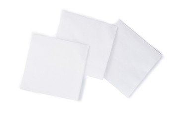 Group of white closeup square papper napkins isolated on white background