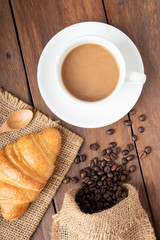 Wall Mural - Coffee and croissant on wooden background