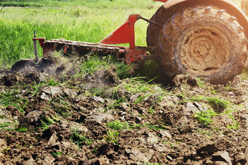 tractor plowing for planting. agriculture at local