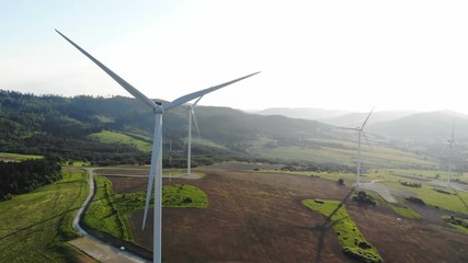 Wall Mural - beautiful green meadow with wind turbines converting kinetic energy into electrical future technology eco life windmill blades successful electric industry eco-worthy system business ecosystem