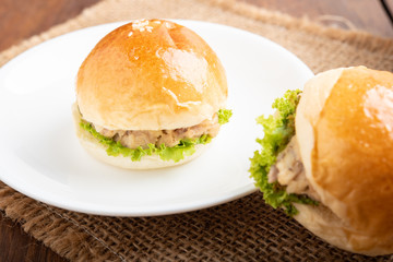 tuna burger and coffee on wood background.