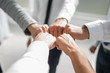 Close up .businessman and businesswoman making a fist bump on building background