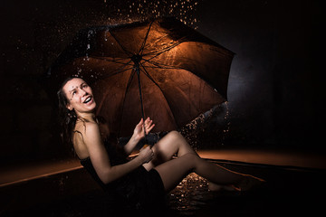 Wall Mural - Girl in black dress with umbrella and drops of water