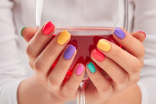 Big Glass Of Wine In Manicured Hands. Young Woman Hands With Trendy Summer Manicure Holding Glass Of Red Wine Close Up. Beautiful Summer Manicure.