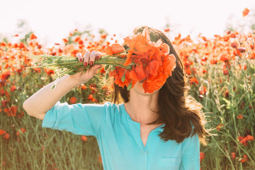 Sticker - Girl covered her face with bouquet of poppies.