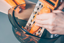The Cook Rubs Carrots On A Grater