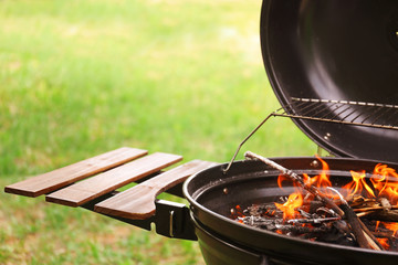 Modern barbecue grill with fire flames outdoors