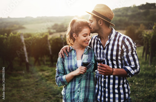 Fotografie, Obraz Couple in love working at winemaker vineyard