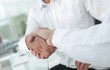 © ASDF - close-up handshake of business colleagues.