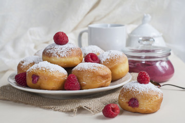 Wall Mural - Breakfast with Krapfen (or berliner, or doughnut, or bombolone) made from yeast dough fried, with berry curd filling, powdered conventional sugar on top.