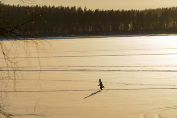 Children in skandinavien winter sunset on frozen lake