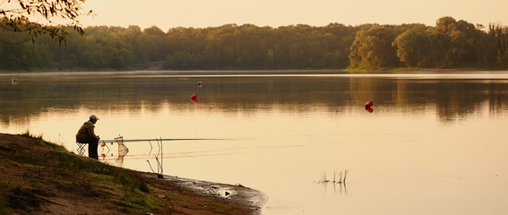 the fisherman catches on the lake at dawn.