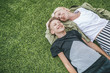 © LIGHTFIELD STUDIOS - high angle view of happy mother and son laughing while lying together on green grass