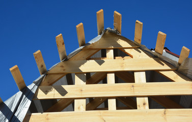 Wall Mural - Close up on home wooden roofing construction. Installing wooden rafters, logs, eaves, timber on house building.