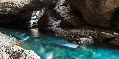 Panorama of the underground lake in a cave of bright blue color