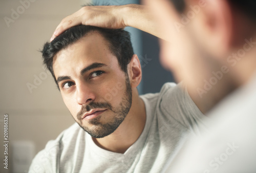 Fotografia, Obraz Man Worried For Alopecia Checking Hair For Loss