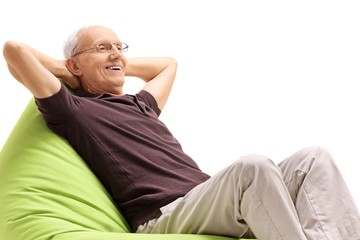 Canvas Print - Relaxed senior sitting on a beanbag