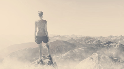 Wall Mural - vintage toned image of woman on a mountain summit