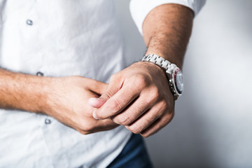 Man in white shirt and metallic wrist watch