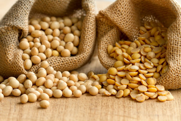 Dry seed of bean product, soy bean in sack close up. Concept: grocery background, soy milk, soy product.