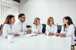 © bnenin - Clinic, people, healthcare and medicine concept. Group of medical staff talking in a meeting.