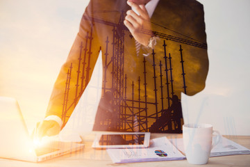 Businessman in suit uniform double exposure construction site silhouette