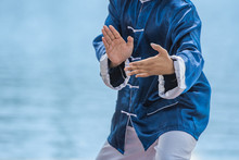 Young Man Practicing Traditional Tai Chi Chuan, Tai Ji And Qi Gong In The Park For Healthy, Traditional Chinese Martial Arts Concept.