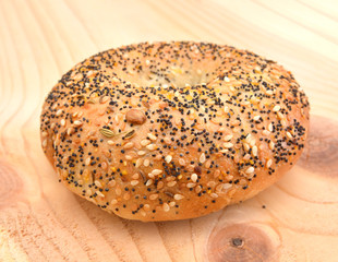 Wall Mural - Everything Bagel Isolated on wooden board background