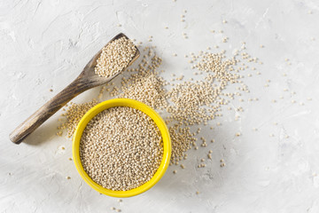 Canvas Print - organic quinua cereal in color bowl on white background