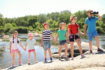 Poster - Little children with binoculars outdoors. Summer camp