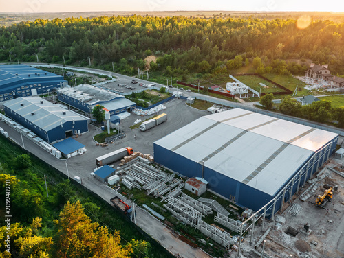Fotografie, Obraz Aerial view of warehouse storages or industrial factory or logistics center from above