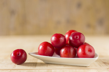 Wall Mural - pile of red plums on the wooden table