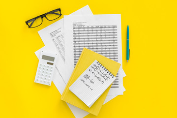 Wall Mural - Math homework. Math textbook or tutorial near sheet with numbers, countes, calculator, notebook with formula on yellow background top view copy space