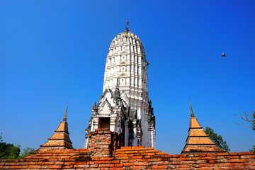 Travel Thailand - Pagoda in Wat Phutthaisawan on blue sky background, Ayutthaya Historical Park. The brick pagoda at old ayutthaya temple ruins. Space for text in template.