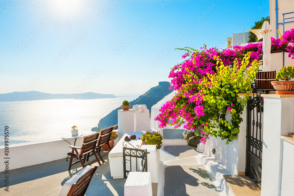 Beautiful terrace with pink flowers on Santorini island, Greece - obrazy, fototapety, plakaty 