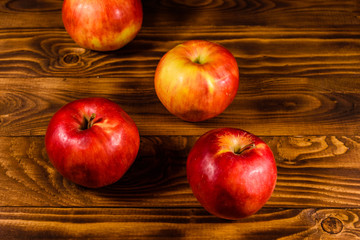 Ripe red apples on the wooden table