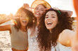 Three joyful multiethnic women 20s in summer clothing smiling at camera, while taking selfie photo during holiday on nature