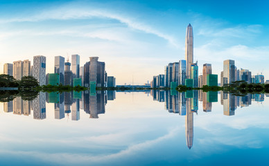 Beautiful modern city skyline and water reflection in Shenzhen at sunrise