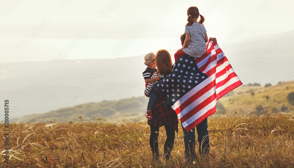 happy family with flag of america USA at sunset outdoors - obrazy, fototapety, plakaty 