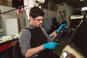 Mechanic with a car polisher