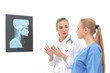© thbangkok - Doctors women discussion and reviewing a resonance magnetic imaging or x ray film checking skull of human head nn examination room. Isolated on white background.
