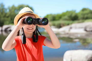 Wall Mural - little girl with binoculars outdoors. summer camp