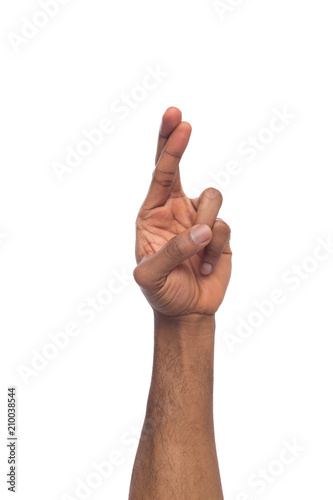 Black hand crossed fingers fo luck isolated on white Tableau sur Toile