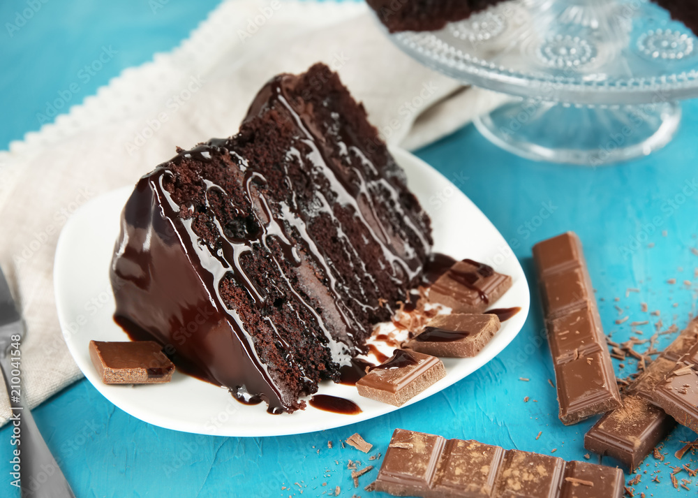 Plate with piece of chocolate cake on table