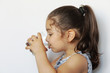 © kaganskaya115 - Cute little girl holding glass of water. and Child drinking water.
