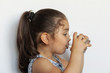 © kaganskaya115 - Cute little girl holding glass of water. and Child drinking water.